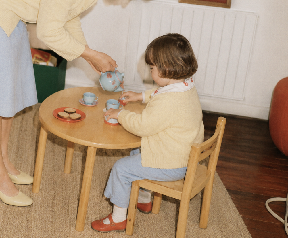 Enfant jouant à table avec un adulte